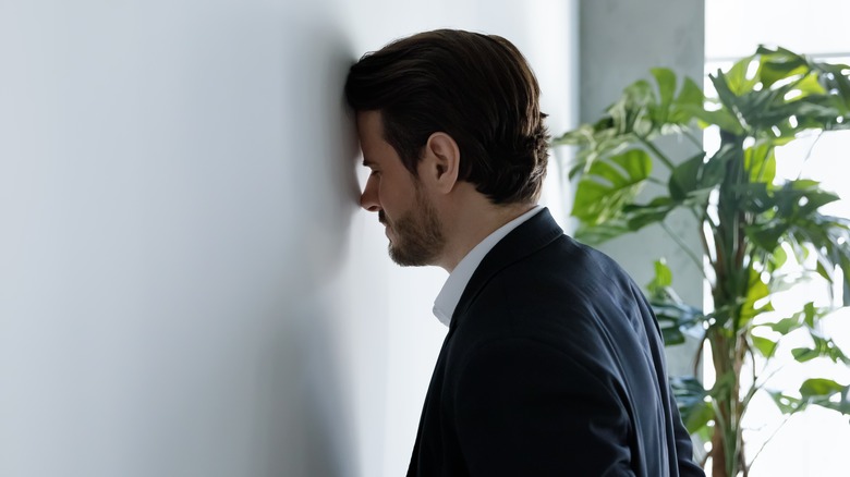 Man having trouble focusing at work
