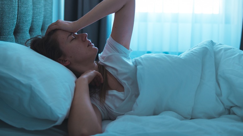 Woman in bed looking depressed